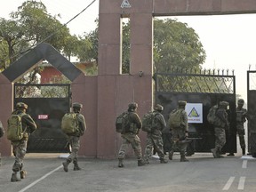 Indian Army soldiers enter Sunjwan Army camp in Jammu, India, Saturday, Feb. 10, 2018. A group of militants in Indian Kashmir opened fire Saturday inside an army camp in the disputed region, police said. The attack began early in the morning and it was unclear how many gunmen were involved,