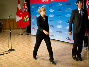 Ontario Premier Kathleen Wynne leaves after holding a press conference on the closing of Leamington's Heinz ketchup plant, at the Caboto Club in Windsor on Nov. 22, 2013.