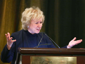 A fully-sleeved Kim Campbell speaks at a Calgary event in October 2017.