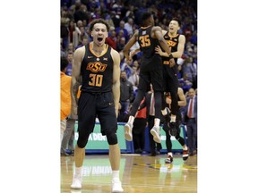 Oklahoma State guard Jeffrey Carroll (30) celebrates following an NCAA college basketball game against Kansas in Lawrence, Kan., Saturday, Feb. 3, 2018. Oklahoma State defeated No. 7 Kansas 84-79.