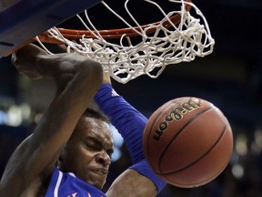 Kansas guard Lagerald Vick dunks during the first half of an NCAA college basketball game against West Virginia in Lawrence, Kan., Saturday, Feb. 17, 2018.
