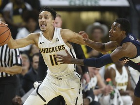 Wichita State guard Landry Shamet (11) steals the ball and is fouled by Connecticut guard Christian Vital during the first half of an NCAA college basketball game Saturday, Feb. 10, 2018, in Wichita, Kan.