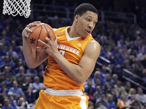 Tennessee's Grant Williams pulls down a rebound during the first half of an NCAA college basketball game against Kentucky, Tuesday, Feb. 6, 2018, in Lexington, Ky.