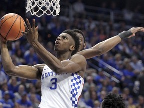 CORRECTS DATE Kentucky's Hamidou Diallo (3) shoots while defended by Alabama's Donta Hall during the first half of an NCAA college basketball game, Saturday, Feb. 17, 2018, in Lexington, Ky.
