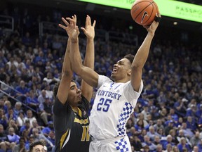Kentucky's Pj Washington (25) shoots while defended by Missouri's Jontay Porter (11) during the first half of an NCAA college basketball game Saturday, Feb. 24, 2018, in Lexington, Ky.