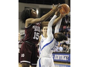 Mississippi State's Teaira McCowan (15) pulls a rebound away from Kentucky's Amanda Paschal (12) during the fourth quarter of an NCAA college basketball game, Sunday, Feb. 25, 2018, in Lexington, Ky. Mississippi State won 85-63.