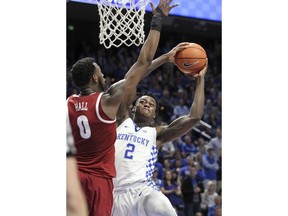 RETRANSMISSION TO CORRECT DATE - Kentucky's Jarred Vanderbilt (2) shoots while pressured by Alabama's Donta Hall (0) during the second half of an NCAA college basketball game, Saturday, Feb. 17, 2018, in Lexington, Ky. Kentucky won 81-71.