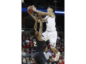 Cincinnati's Jarron Cumberland (34) shoots against Central Florida's Terrell Allen (2) in the first half of an NCAA college basketball game, Tuesday, Feb. 6, 2018, in Highland Heights, Ky.
