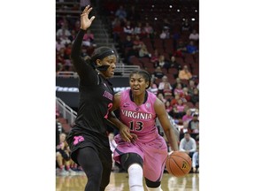 Virginia guard Jocelyn Willoughby (13) attempts to drive past the defense of Louisville forward Myisha Hines-Allen (2) during the first half of an NCAA college basketball game, Thursday, Feb. 22, 2018, in Louisville, Ky.