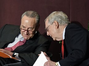 Senate Minority Leader Charles Schumer, D-N.Y., left, talks with Senate Majority Leader Mitch McConnell, R-Ky., before his speech at the McConnell Center's Distinguished Speaker Series Monday, Feb. 12, 2018, in Louisville, Ky.