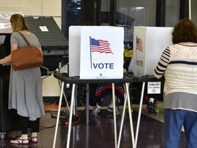 Voters cast their ballots at Cedar Grove Elementary School, Tuesday, Feb. 20, 2018, in Shepherdsville, Ky. A special election is being held in Kentucky's 49th House District to fill the vacancy left by former representative, Dan Johnson, who committed suicide in 2017.