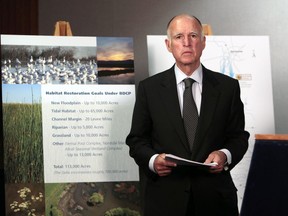 FILE - In this July 25, 2012 file photo, California Gov. Jerry Brown prepares to announce plans to build a giant twin tunnel system to move water from the Sacramento-San Joaquin River Delta to farmland and cities at a news conference in Sacramento. Brown is scaling back his troubled proposal for overhauling California's water system, at least for now. State official Karla Nemeth wrote Wednesday, Feb. 7, 2018, that the Brown administration is looking at building a single giant water tunnel now.