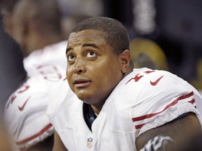 FILE - This Aug. 28, 2014, file photo shows San Francisco 49ers' Jonathan Martin on the bench during an NFL football preseason game against the Houston Texans in Houston. A law enforcement official says ex-football player Martin was taken into Los Angeles police custody after a threatening Instagram post that spoke of bullying. The official says Martin was being questioned and was not under arrest. The official was not authorized to discuss the matter publicly and spoke to The Associated Press on condition of anonymity.