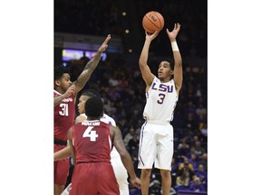 LSU's Tremont Waters (3) shoots a three-point basket in the first half of an NCAA college basketball game against Arkansas in Baton Rouge, La., Saturday, Feb. 3, 2018. Arkansas' Anton Beard (31) defends.