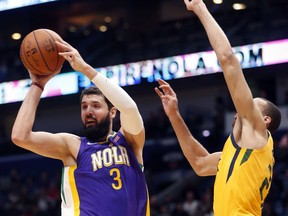 New Orleans Pelicans forward Nikola Mirotic (3) passes around Utah Jazz center Rudy Gobert in the first half of an NBA basketball game in New Orleans, Monday, Feb. 5, 2018.