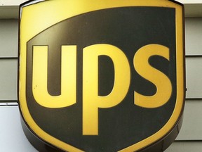 FILE - A Wednesday, April 12, 2017, file photo, showing a UPS logo on the exterior of The UPS Store, in Natick, Mass. U.S. delivery giant UPS has launched court action against the European Union's anti-trust regulator for blocking a merger with Dutch firm TNT and is seeking 1.742 billion euros ($2.14 billion) in compensation.