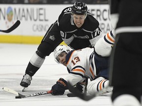 Edmonton Oilers left wing Michael Cammalleri, below, falls as he tries to pass the puck while under pressure from Los Angeles Kings left wing Tanner Pearson during the first period of an NHL hockey game, Wednesday, Feb. 7, 2018, in Los Angeles.