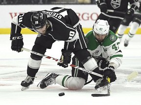 Los Angeles Kings center Tobias Rieder, left, of Germany, and Dallas Stars right wing Alexander Radulov, of Russia, battle for the puck during the first period of an NHL hockey game Thursday, Feb. 22, 2018, in Los Angeles.