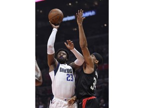 Dallas Mavericks guard Wesley Matthews, left, shoots as Los Angeles Clippers forward Tobias Harris defends during the first half of an NBA basketball game, Monday, Feb. 5, 2018, in Los Angeles.