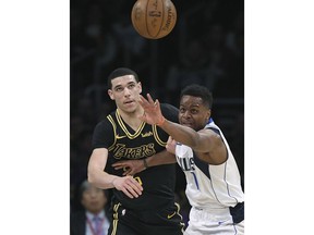 Los Angeles Lakers guard Lonzo Ball, left, and Dallas Mavericks guard Yogi Ferrell watch a loose ball during the first half of an NBA basketball game Friday, Feb. 23, 2018, in Los Angeles.