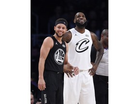 Team Stephen's Stephen Curry, left, of the Golden State Warriors, and Team LeBron's LeBron James, of the Cleveland Cavaliers, stand together during the first half of an NBA All-Star basketball game, Sunday, Feb. 18, 2018, in Los Angeles.