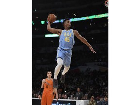 U.S. Team's Donovan Mitchell, of the Utah Jazz, goes up for a dunk as Bogdan Bogdanovic, of the Sacramento Kings, watches during the NBA All-Star Rising Stars basketball game, Friday, Feb. 16, 2018, in Los Angeles. The World Team won 155-124.