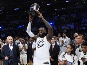 Team LeBron's LeBron James, of the Cleveland Cavaliers, holds the MVP trophy after his team defeated Team Stephen at the NBA All-Star basketball game, Sunday, Feb. 18, 2018, in Los Angeles. Team LeBron won 148-145.