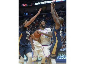 Miami Heat forward James Johnson, center, drives to the basket against New Orleans Pelicans in the first half of an NBA basketball game in New Orleans, Friday, Feb. 23, 2018.