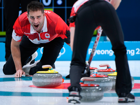 Canada's John Morris shouts instructions as Kaitlyn Lawes brushes the ice surface during the Pyeongchang 2018 Winter Olympic Games.