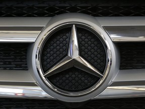 FILE - This Thursday, Feb. 11, 2016 file photo shows the Mercedes logo in the grill of a Mercedes 2016 GLE SUV automobile on display at the Auto Show in Pittsburgh. German automaker Daimler AG says Thursday Feb. 1, 2018, its net profit rose 24 percent to a record 10.9 billion euros ($13.5 billion) last year, helped by strong sales of its Mercedes-Benz SUVs and new E-Class luxury sedan.