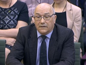 In this image taken from video, Mark Goldring, CEO of Oxfam GB, gives evidence before the Commons Development Committee at Portcullis House, London, Tuesday Feb. 20, 2018. British lawmakers are set to question officials of two anti-poverty charities Tuesday amid concern sex predators are targeting aid organizations because of the chaotic environments in which they work. (PA via AP)