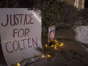A sign and photo of Colten Boushie sits in front of the Court of Queen's Bench on the day of closing arguments and first day of jury deliberation in the trial of Gerald Stanley, the farmer accused of killing the 22-year-old Indigenous man, in Battleford, Sask., Thursday, February 8, 2018.