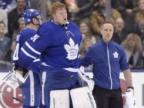 Maple Leafs goaltender Frederik Andersen (31) is helped off the ice fter being hit during a game against the Anaheim Ducks in Toronto on Monday, Feb. 5, 2018.