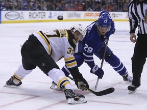 Bruins centre Patrice Bergeron wins a defensive zone faceoff against the Leafs' William Nylander on Feb. 24, 2018.