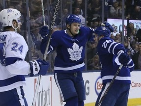 James van Riemsdyk, centre, of the Toronto Maple Leafs is congratulated by teammate Connor Brown after scoring what proved to be the game-winning goal in a 4-3 victory over the Tampa Bay Lightning Monday night at the ACC.