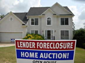 A sign advertising foreclosure and auction is posted outside a home in Decatur, Ga., in a file photo from July 9, 2007. Approximately 2.5 million U.S. homes are worth less than what is owed on their mortgages.