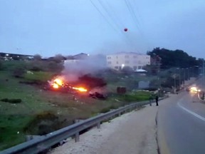 In this image made from video provided by Yehunda Pinto, the wreckage of a jet is seen on fire near Harduf, northern Israel, Saturday, Feb. 10, 2018. The Israeli military shot down an Iranian drone that infiltrated the country early Saturday before launching a "large-scale attack" on at least a dozen Iranian and Syrian targets in Syria.
