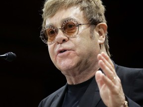 FILE - In this file photo dated  Monday, Nov. 6, 2017, musician Elton John addresses an audience before being presented with the 2017 Harvard Humanitarian of the Year Award on the campus of Harvard University, in Cambridge, Mass. USA.  Elton is widely expected to be among the celebrity guests to the May 19, 2018, royal wedding of Britain's Prince Harry and fiancee Meghan Markle, though the actual guest list is a closely guarded secret.