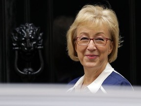 FILE - In this Tuesday, Oct. 10, 2017 file photo, Lord President of the Council, Leader of the House of Commons Andrea Leadsom smiles toward the media as she arrives for a cabinet meeting at 10 Downing Street in London. The leader of Britain's House of Commons said Thursday Feb. 8, 2018, that tough new measures against sexual misconduct will be "a game changer for Parliament," after a survey found one in five parliamentary workers had experienced or witnessed sexual harassment in the past year.