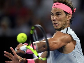 FILE - This is a Tuesday, Jan. 23, 2018  file photo of Spain's Rafael Nadal hits a forehand return to Croatia's Marin Cilic during their quarterfinal at the Australian Open tennis championships in Melbourne, Australia, Tuesday, Jan. 23, 2018.  Nadal said Monday Feb. 5, 2018  that he is recovering well from the muscle injury that forced him to retire in the quarterfinals of the Australian Open last month.