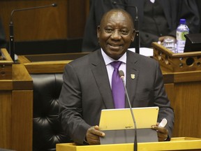 FILE - In this Friday, Feb. 16, 2018 file photo, South Africa's new President, Cyril Ramaphosa, delivers his State of the Nation address in parliament in Cape Town, South Africa. South African President Cyril Ramaphosa has announced a Cabinet shuffle that replaces the finance minister and puts a former finance minister, Malusi Gigaba, in charge of the country's troubled state-owned companies.