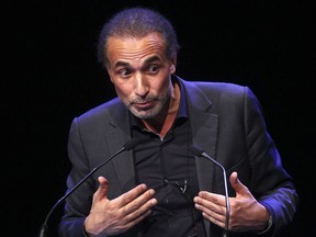 FILE - In this Feb.7 2016 file photo, Muslim scholar Tariq Ramadan delivers a speech during a French Muslim organizations meeting in Lille, northern France.  A French judge has decided to keep prominent Islamic scholar Tariq Ramadan in detention, Tuesday, Feb. 6, 2018, four days after he was charged with two alleged cases of rape by women who sought his counsel.