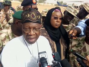 In this image taken from video, Lai Muhammed, Nigerian Minister of Information, speaks to the media in Dapchi, Yobe State, Nigeria, on Thursday Feb. 22, 2018. Parents in northern Nigeria say more than 100 girls are still missing three days after suspected Boko Haram extremists attacked their school. The announcement comes after government officials in Yobe state acknowledged that some 50 young women remained unaccounted for in the Monday evening attack. (AP Photo)