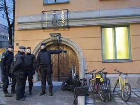 Police officers stand outside a  court in Stockholm  Tuesday February 13, 2018. The trial has started of an Uzbek man Rakhmat Akilov who has confessed to ramming a stolen truck into a crowd in downtown Stockholm last year, killing five and injuring 14. Akilov appeared Tuesday before the Stockholm District Court where he is charged with terror-related murder and attempted murder.