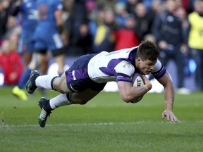 Scotland's Huw Jones scores his side's second try of the game against France during the six nations rugby match at BT Murrayfield, Edinburgh, Scotland, Sunday Feb. 11, 2018.
