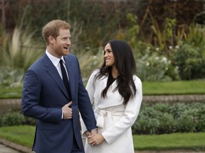 FILE - In this file photo dated  Monday Nov. 27, 2017, Britain's Prince Harry and his fiancee Meghan Markle pose for photographers in the grounds of Kensington Palace in London, following the announcement of their engagement. Speculation is mounting over who will be invited to the May 19, 2018, royal wedding of Prince Harry and Meghan Markle, with pundits guessing about the wedding guest list.