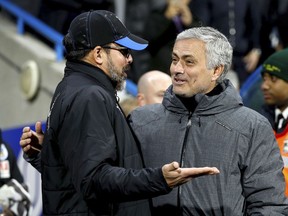 Huddersfield Town manager David Wagner, left, and Manchester United manager Jose Mourinho speak before the English FA Cup, fifth round soccer match at The John Smith's Stadium, Huddersfield, England, Saturday Feb. 17, 2018.