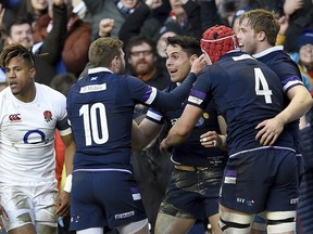 Scotland's Sean Maitland, centre, celebrates scoring his side's second try against England during their Six Nations rugby match at BT Murrayfield in Edinburgh, Scotland, Saturday Feb. 24, 2018.