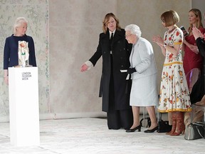 Queen Elizabeth II prepares to present to Richard Quinn the inaugural Queen Elizabeth II Award for British Design.