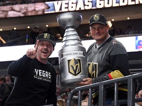 Vegas Golden Knights fans Mike Forizs (left) and Derek Frank, both of Neavada, pose with a homemade version of the Stanely Cup before a game against the Los Angeles Kings on Feb. 27.
